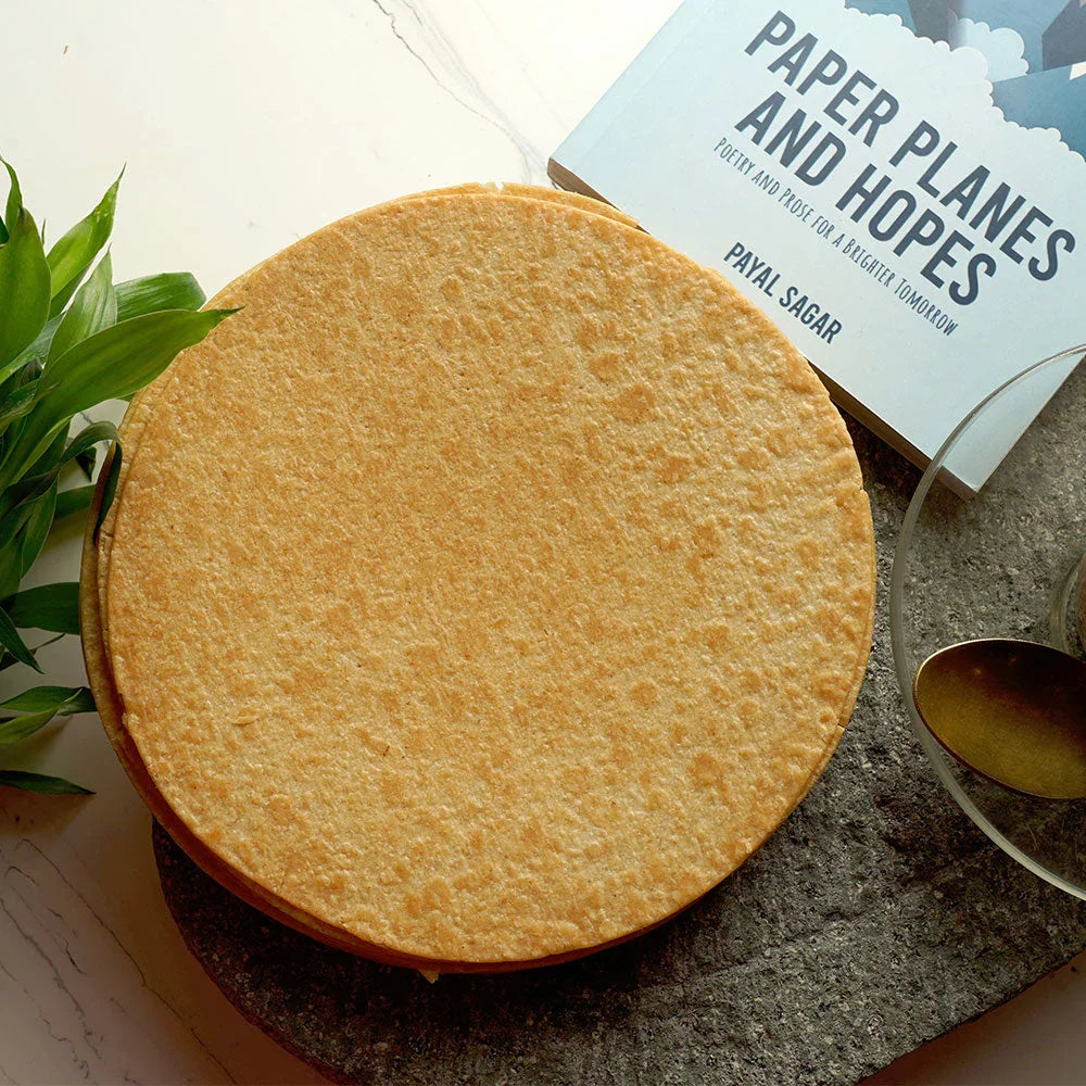 Stack of golden-brown Plain Khakhra, highlighting its thin, crunchy texture.
