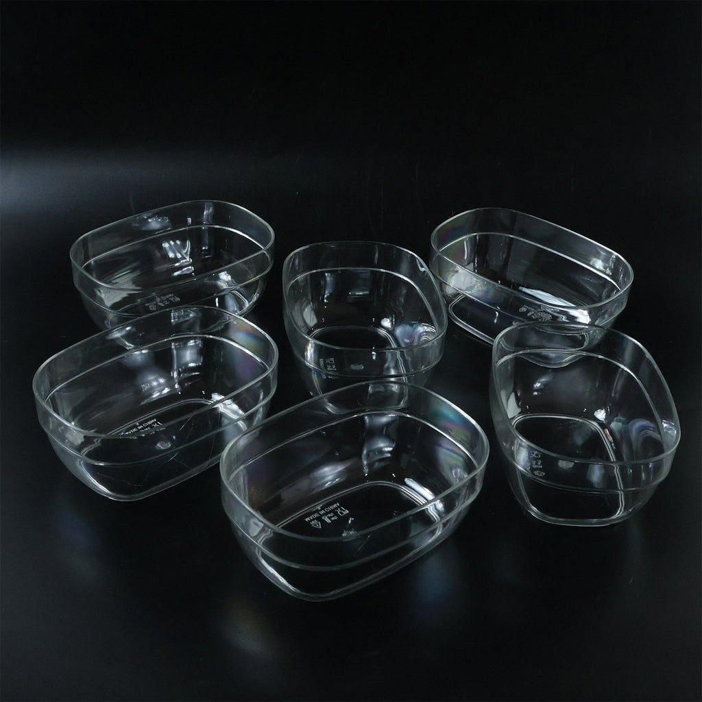 Oval clear serving bowls in use for presenting fresh salads