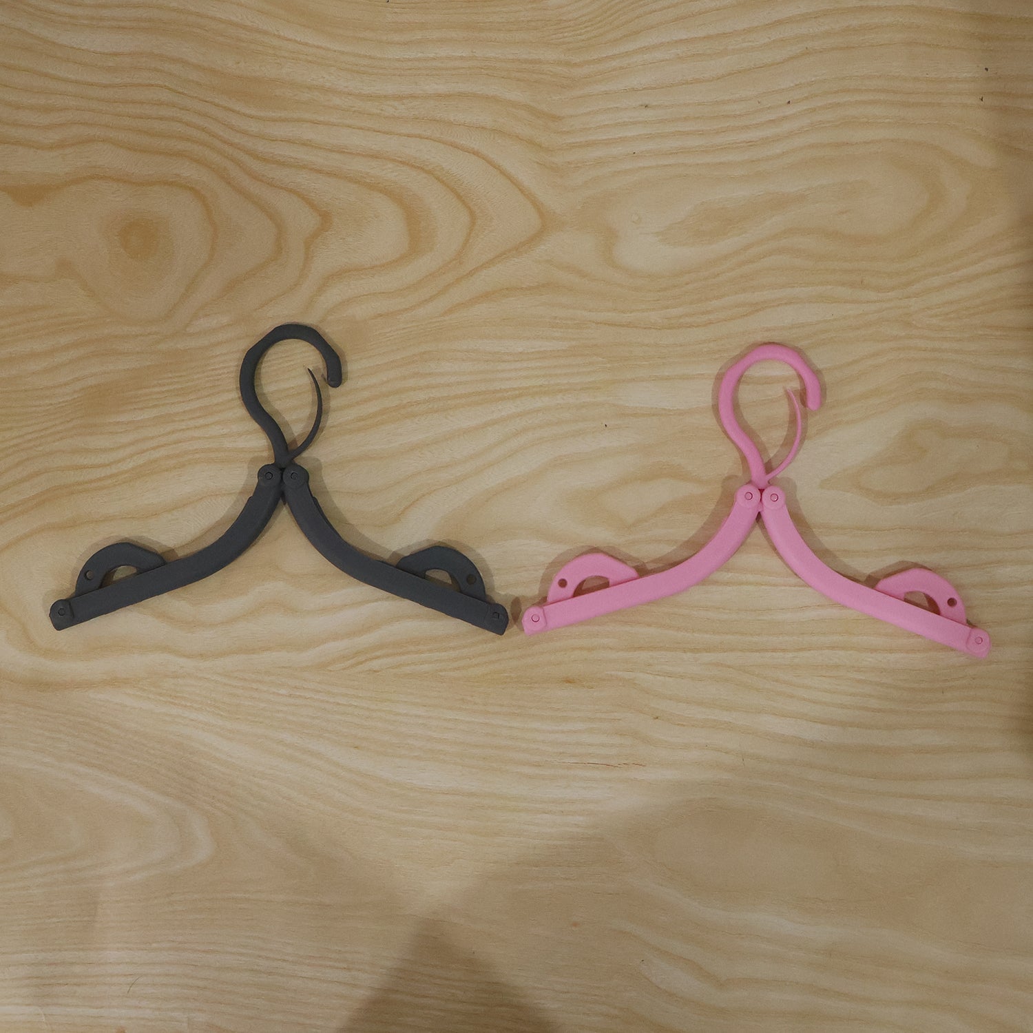 Bright colored foldable hanger designed for organizing wardrobe efficiently