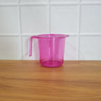 Plastic bathroom mug in a modern bathroom setting.