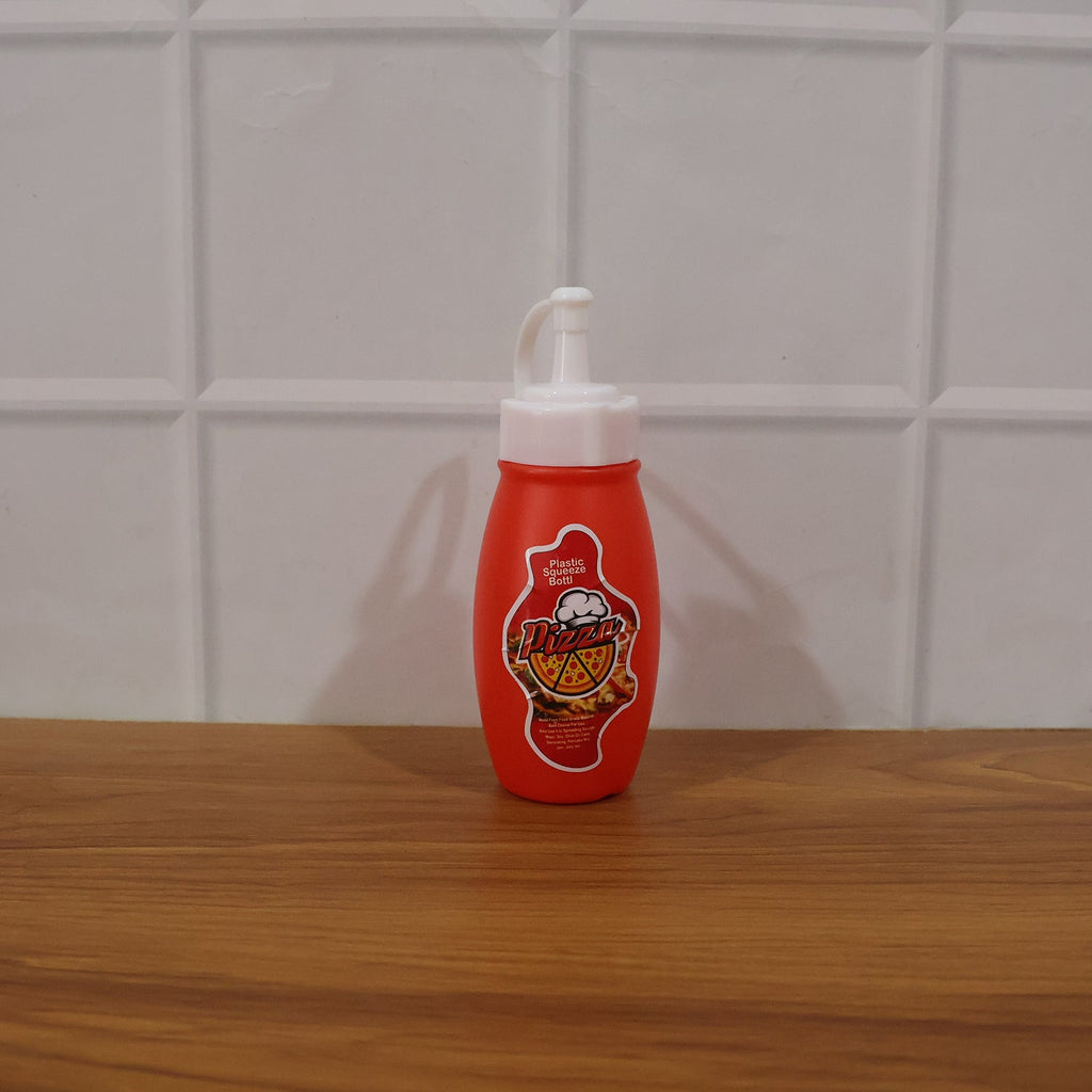 Close-up of plastic squeeze sauce bottle in kitchen setting