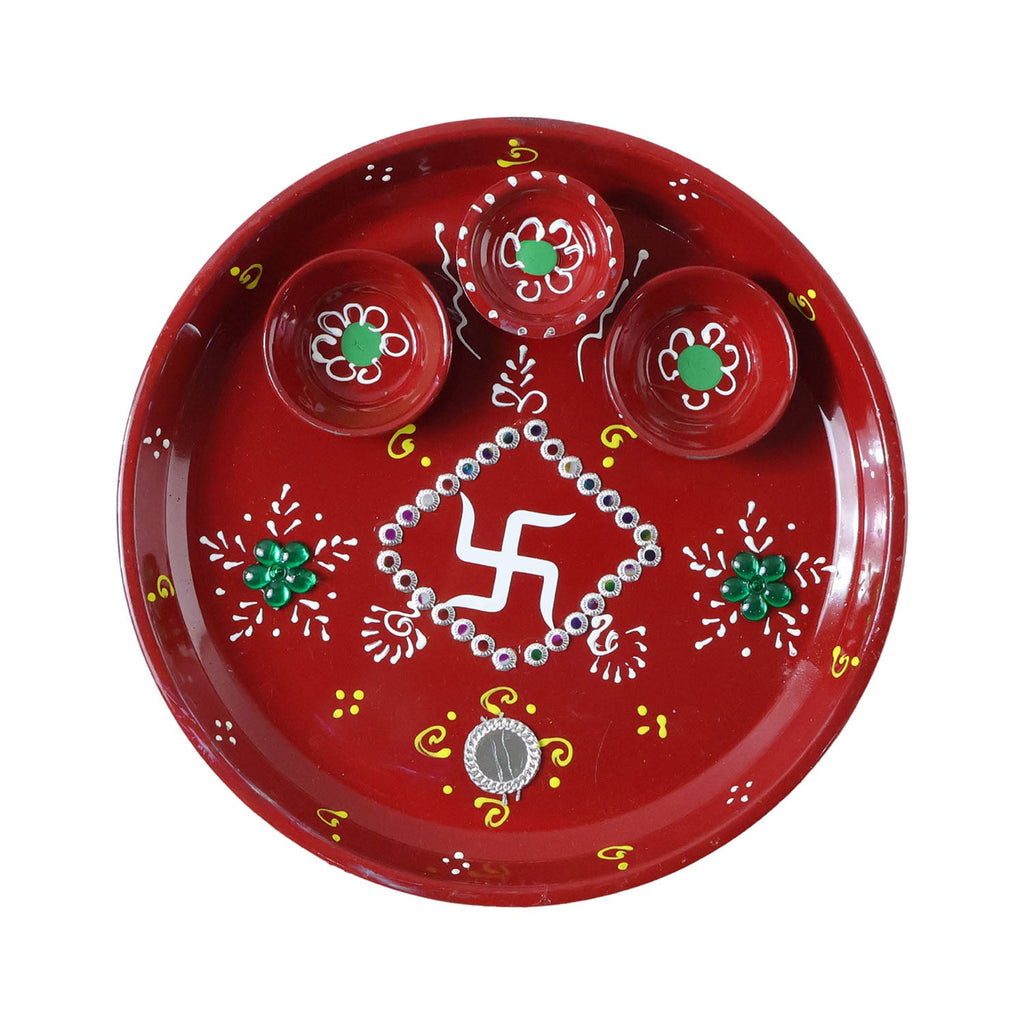 Three diyas arranged on vibrant hand-painted pooja thali for festivals