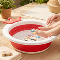 Foldable baby bathtub with non-slip base, crown shape, and cow face design for infants