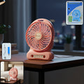 Portable USB rechargeable desk fan on office desk providing personal cooling