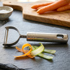 Peeler near sliced vegetables for food prep