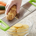 Hand holding the compact potato slicer, demonstrating its ergonomic grip and ease of use.