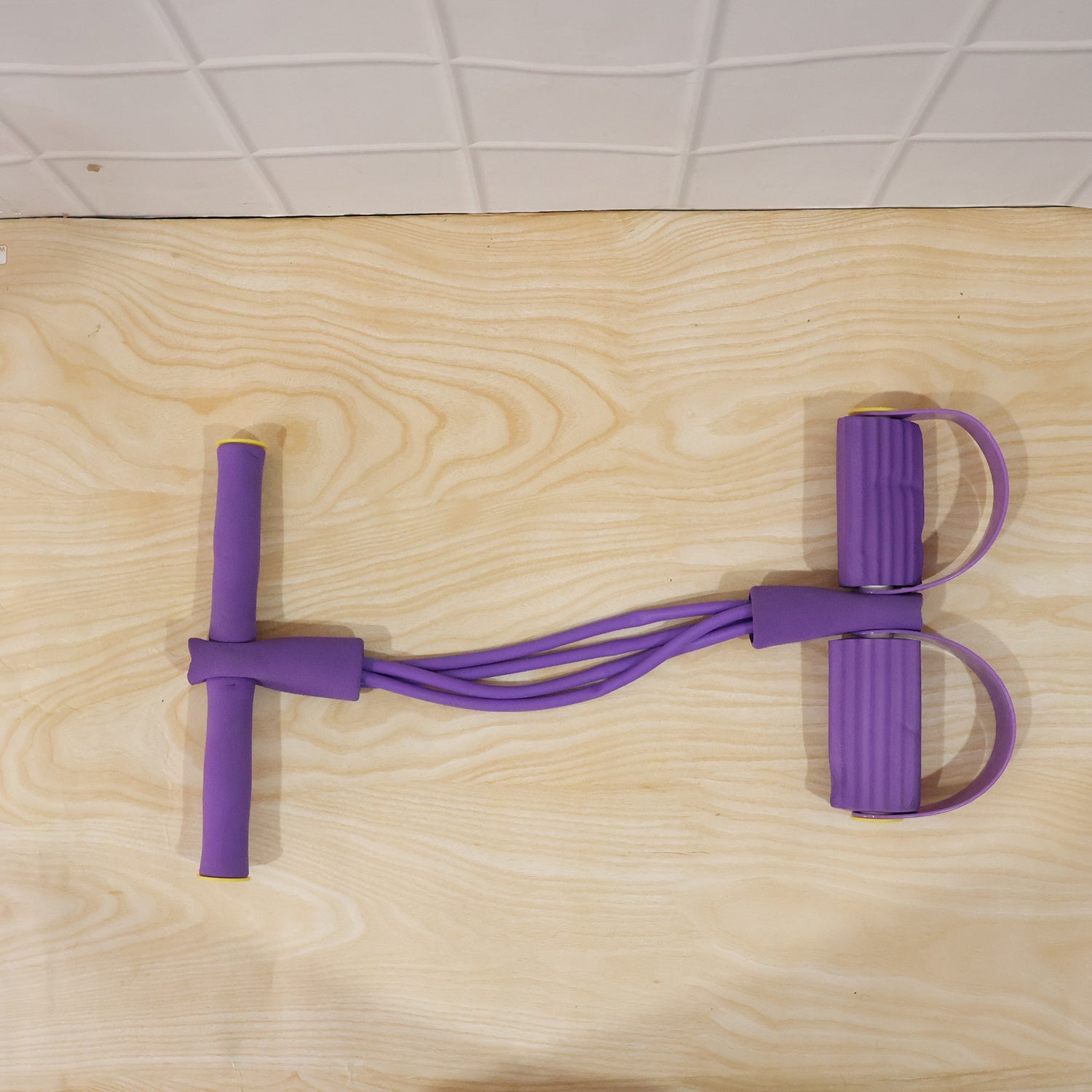 User demonstrating pull rope resistance exerciser during workout