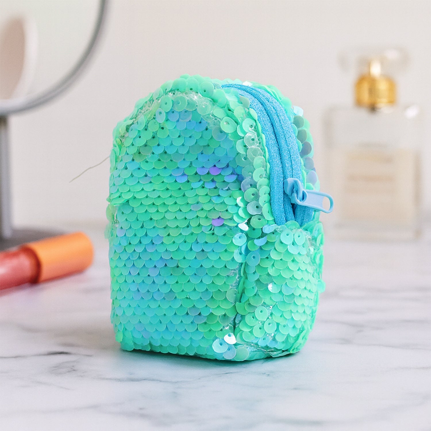 Open sequin zipper pouch revealing the soft inner lining and ample space.