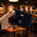 Close-up of zipper pocket detail on black card holder wallet