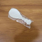 Rice serving spoon placed in kitchen setting with other utensils