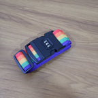 Rainbow Luggage Strap securing a black suitcase, making it easy to spot.