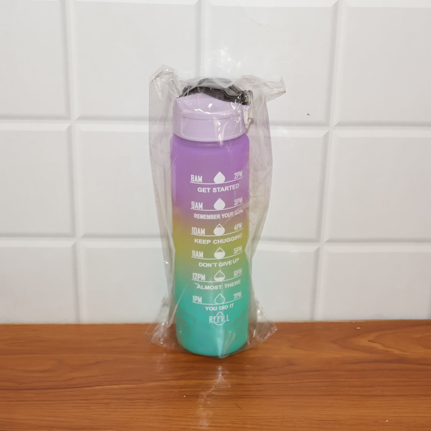 Motivational Water Bottle placed next to gym gear, perfect for fitness enthusiasts and active lifestyles.