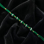 Close-up of green pearl beaded rakhi design