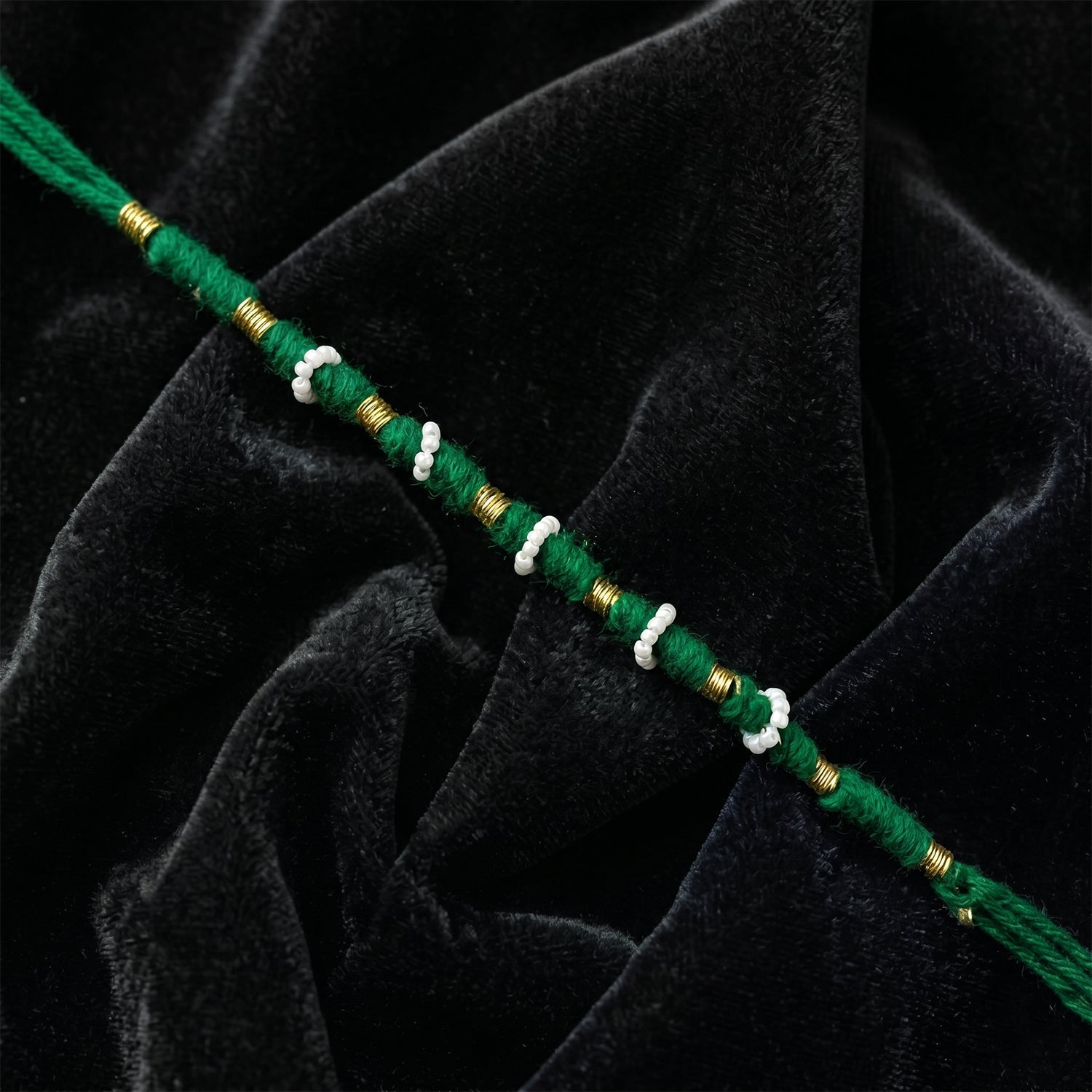 Close-up of green pearl beaded rakhi design