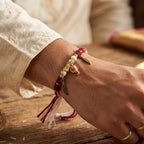 Designer Ganesh rakhi with gold charms and feather details