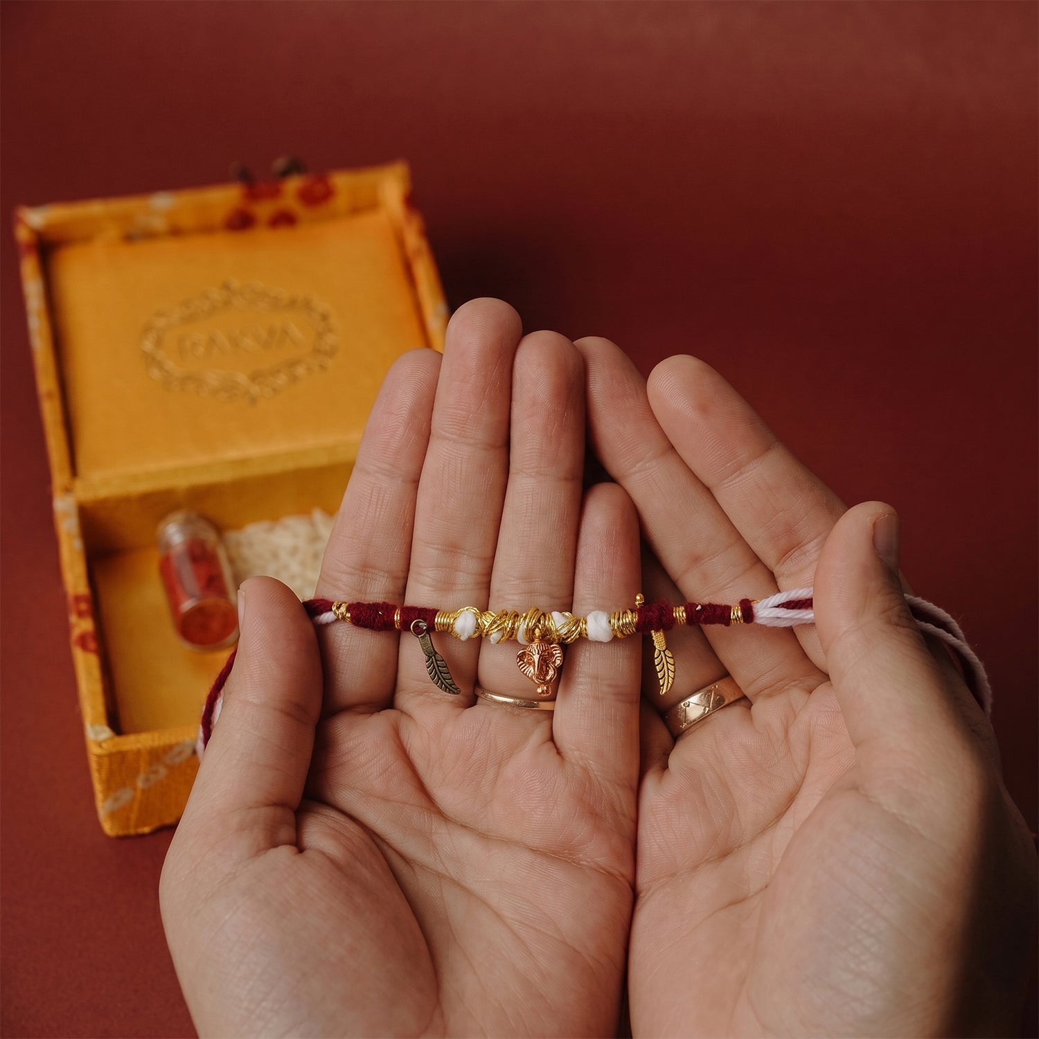 Handmade pearl beaded rakhi with Ganesh charm