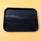Close-up detail of smooth surface and rounded corners on black plastic serving tray