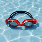 Detailed look at red swimming goggles emphasizing anti-fog lenses