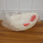 Empty fish-shaped rice drainer, ready for washing grains or produce.