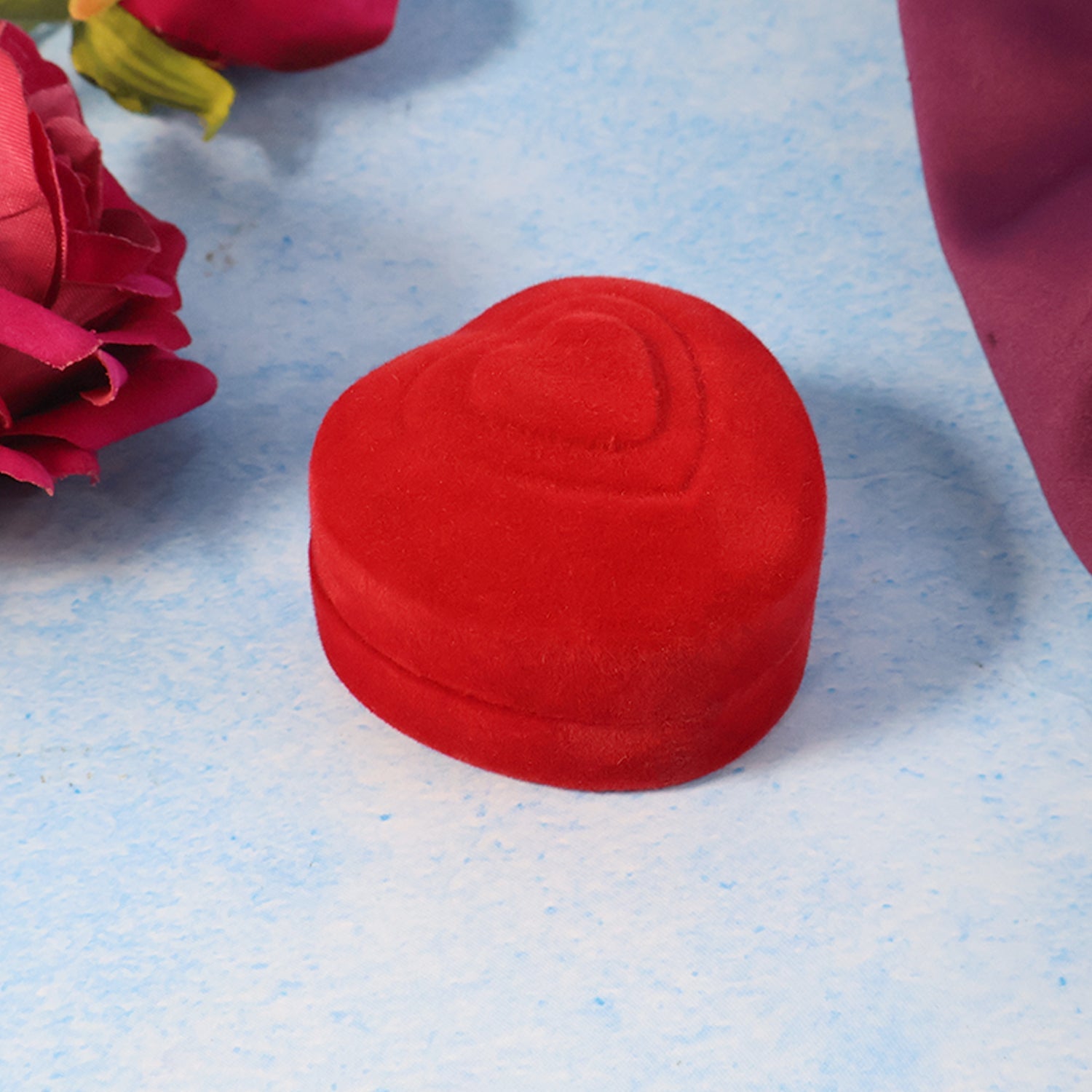 Heart-shaped velvet box open to reveal plush interior ideal for ring proposals