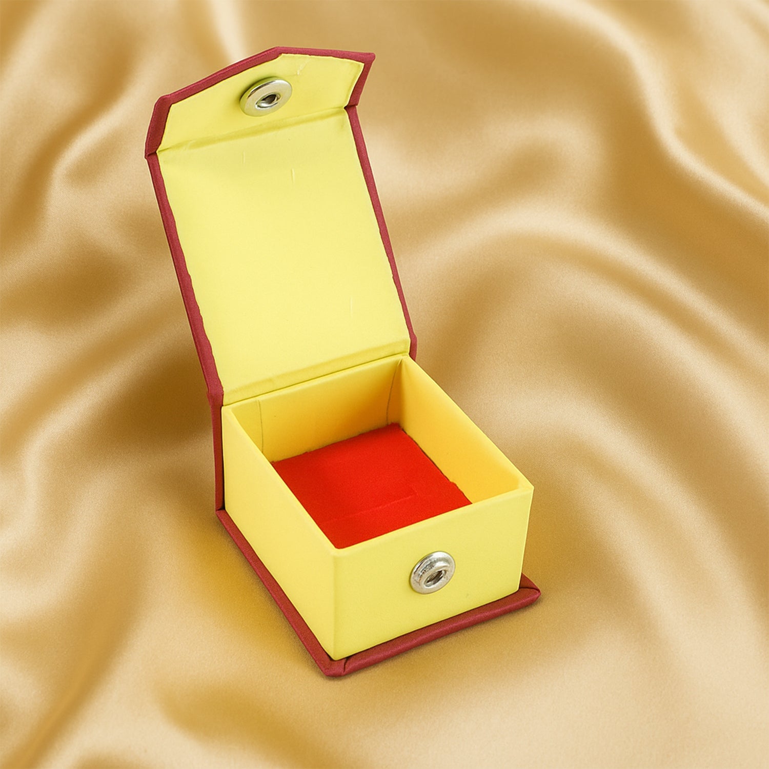 Open ring gift box showing soft velvet cushion and snap closure