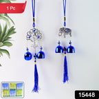 Close-up of metal evil eye wind chime with blue and gold design