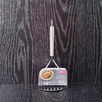 Potato masher in kitchen environment with ergonomic handle