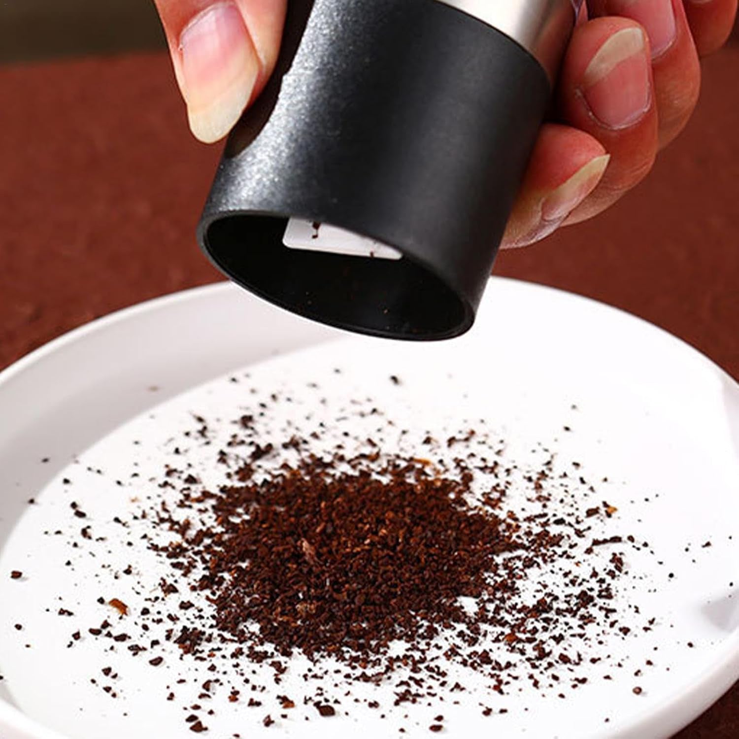 Stylish stainless steel salt and pepper grinder placed on kitchen countertop
