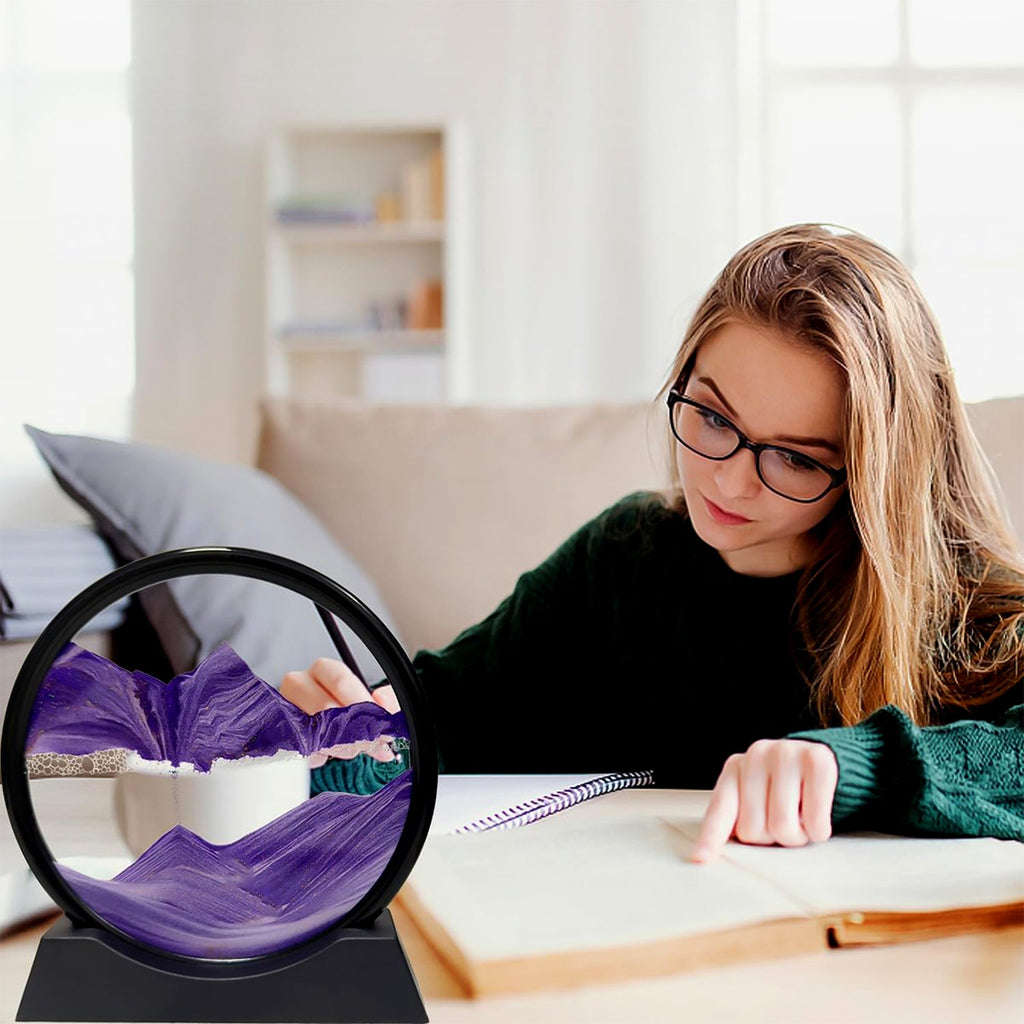 Styleva 3D Moving Sand Art with its round frame, placed on a clean white desk surface.