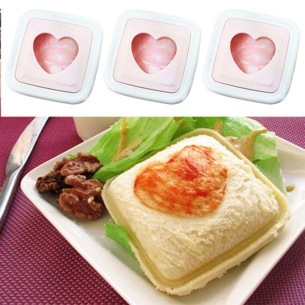 Heart sandwich cutter placed beside bread loaf on kitchen counter