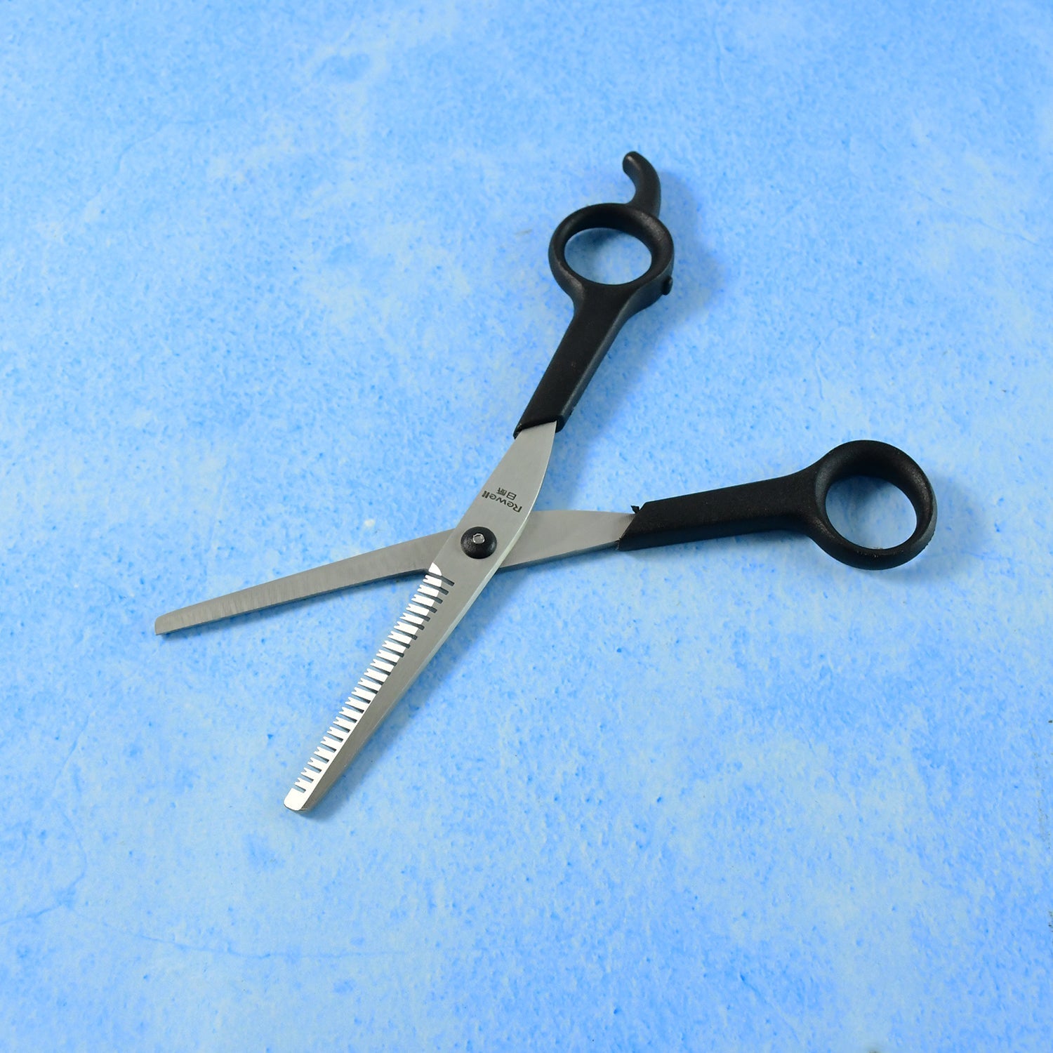 Close-up angled view of hair thinning scissors focusing on cutting details