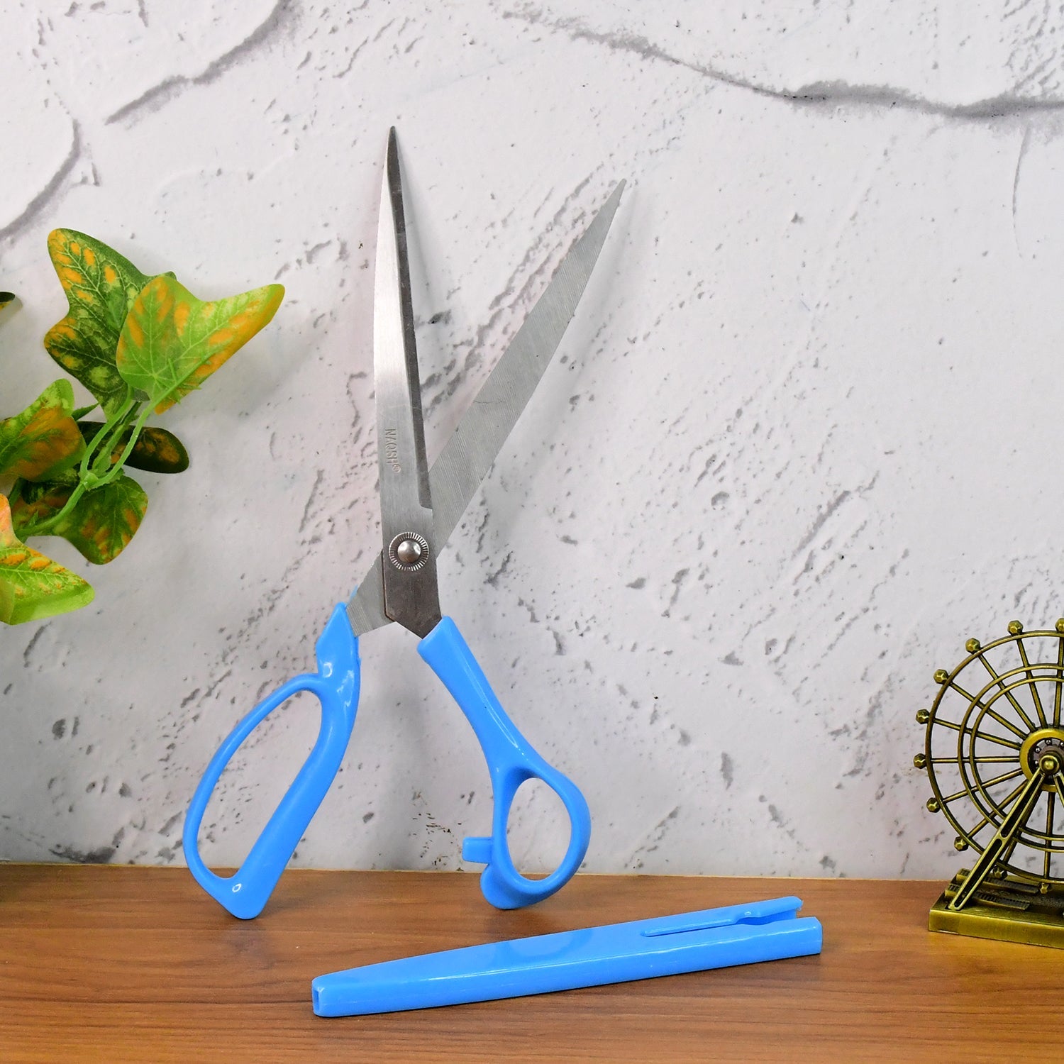 Angled side view of the Carbo Titanium scissors, highlighting the ergonomic bent handle.