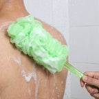 Person using the 45cm long handle shower body scrubber to reach their back.