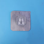 Double-sided transparent adhesive wall hook in use