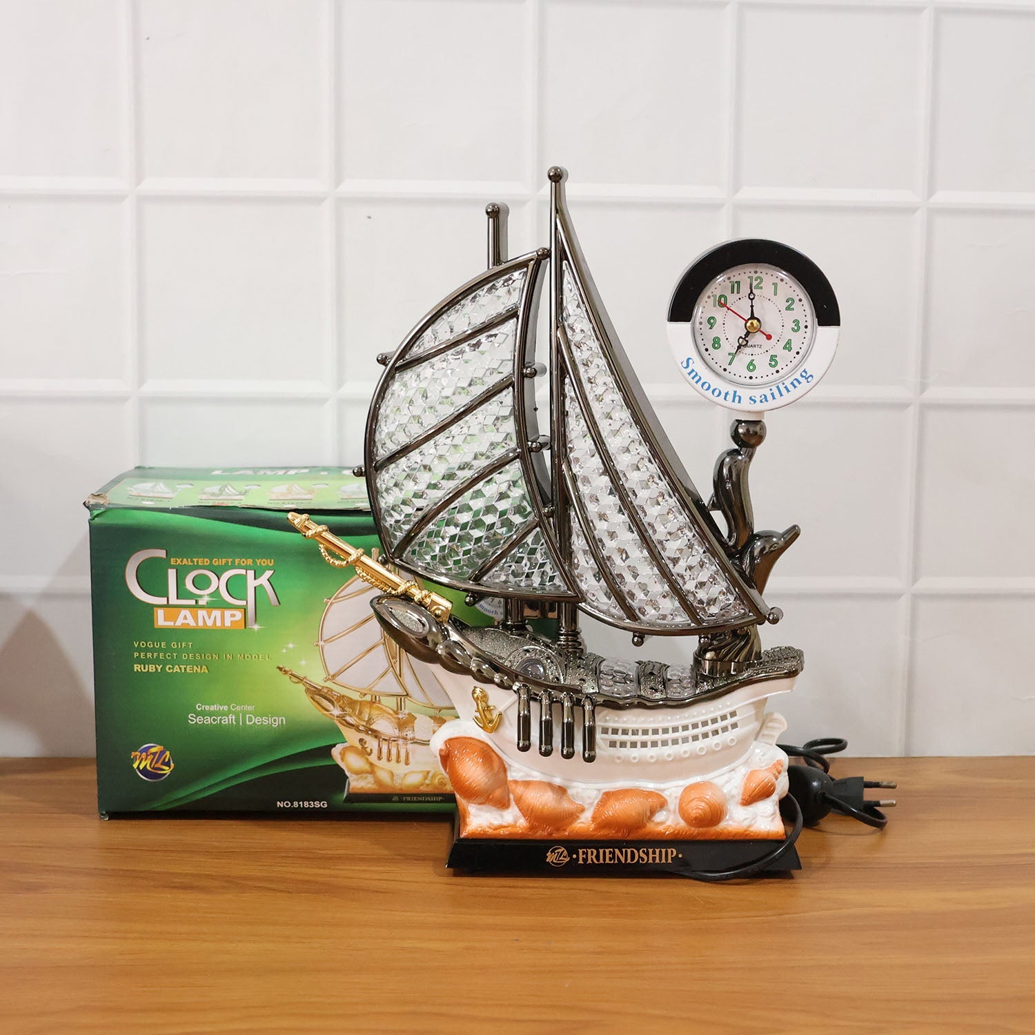 Decorative ship shaped clock lamp placed on office desk for decor