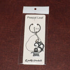 Spiritual metal keychain featuring Om symbol and Shivling icon