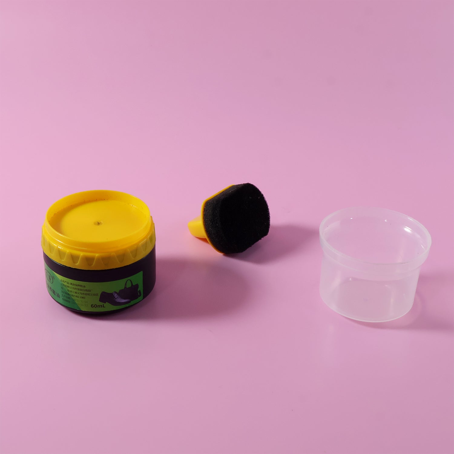 Black shoe polish cream container shown with open lid