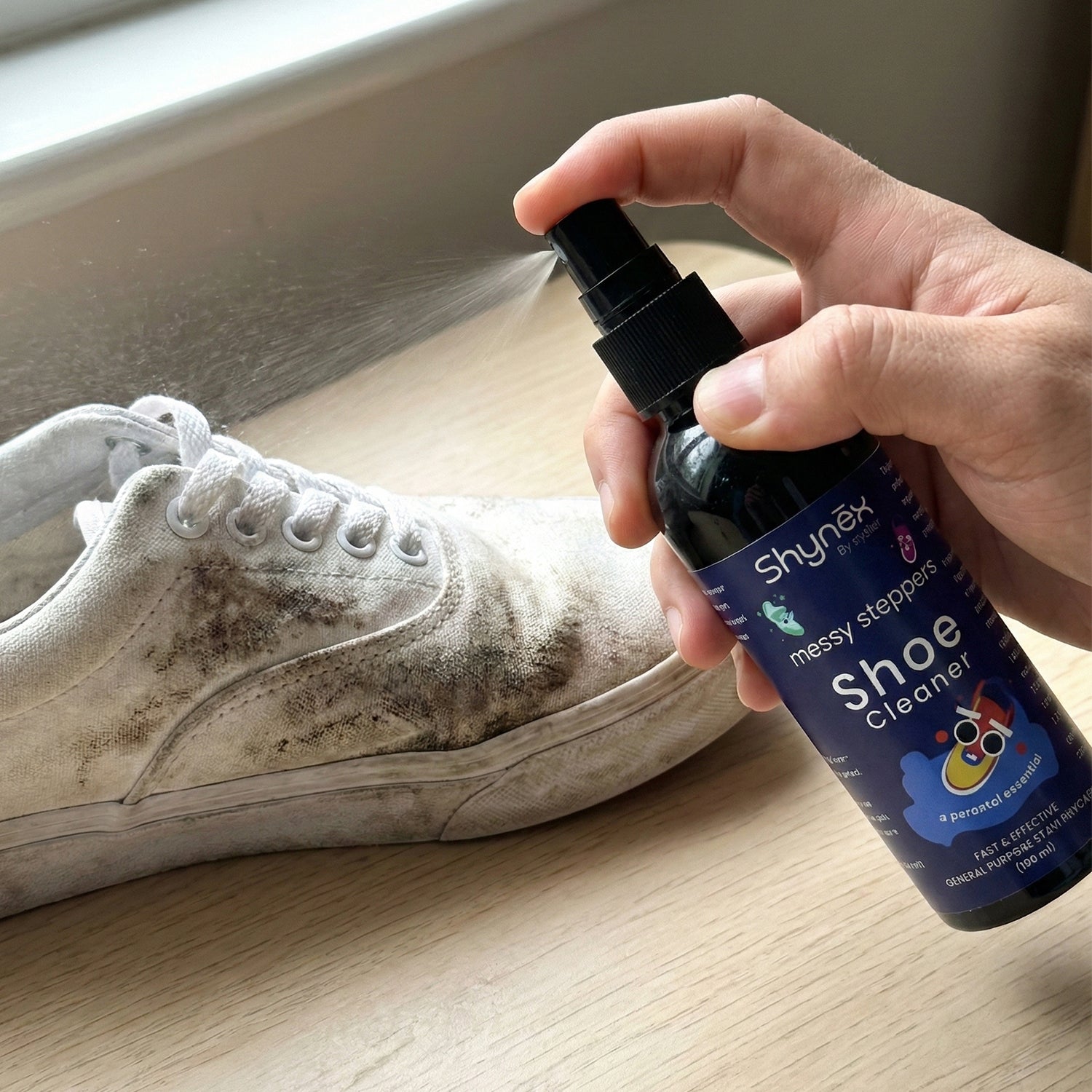 Shoe Cleaner Spray applied on white sneakers to remove stains