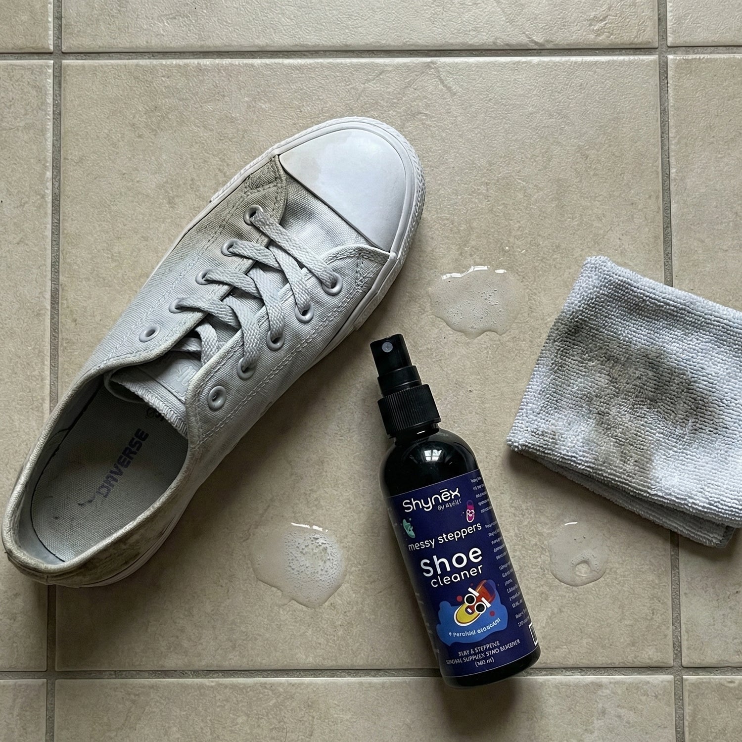Shoe Cleaner Spray bottle positioned next to clean shoes