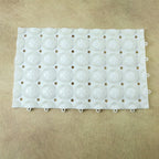 Person standing on textured anti-slip massage bath mat