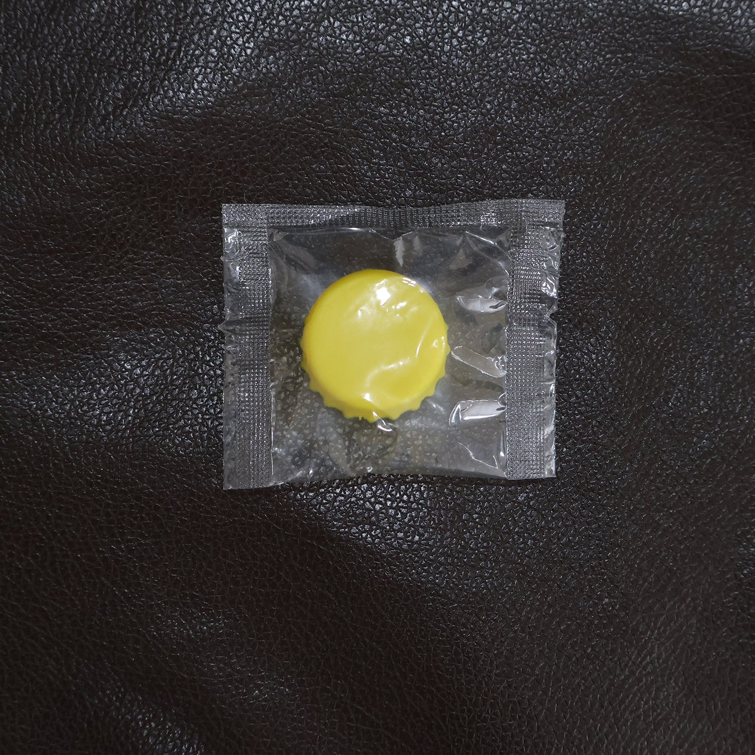 Reusable silicone bottle cap cover in use