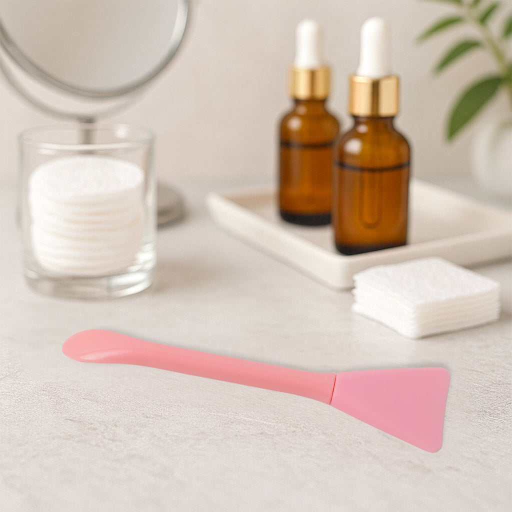Mask applicator spatula applying skincare product smoothly