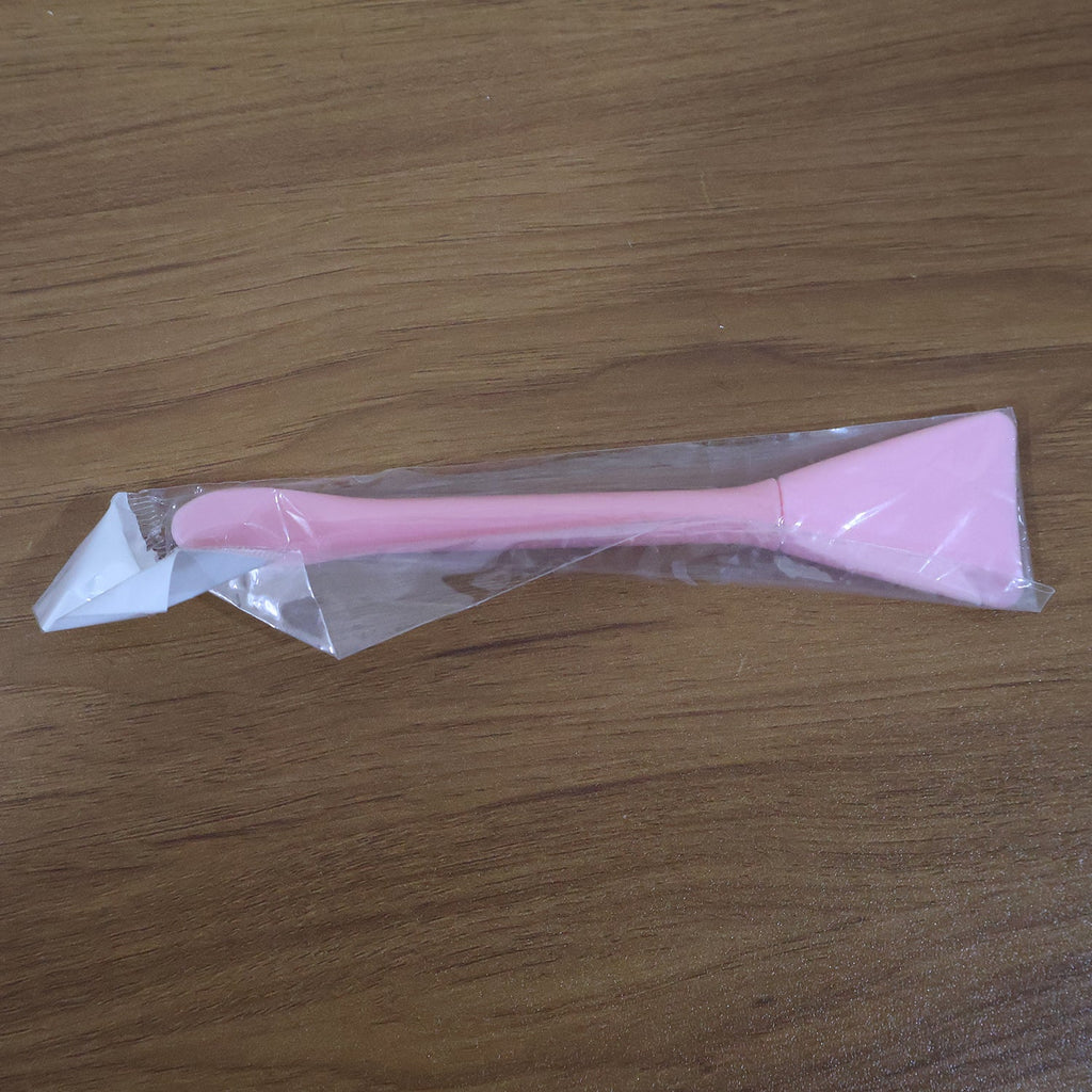 Close-up image of silicone facial mask applicator tool