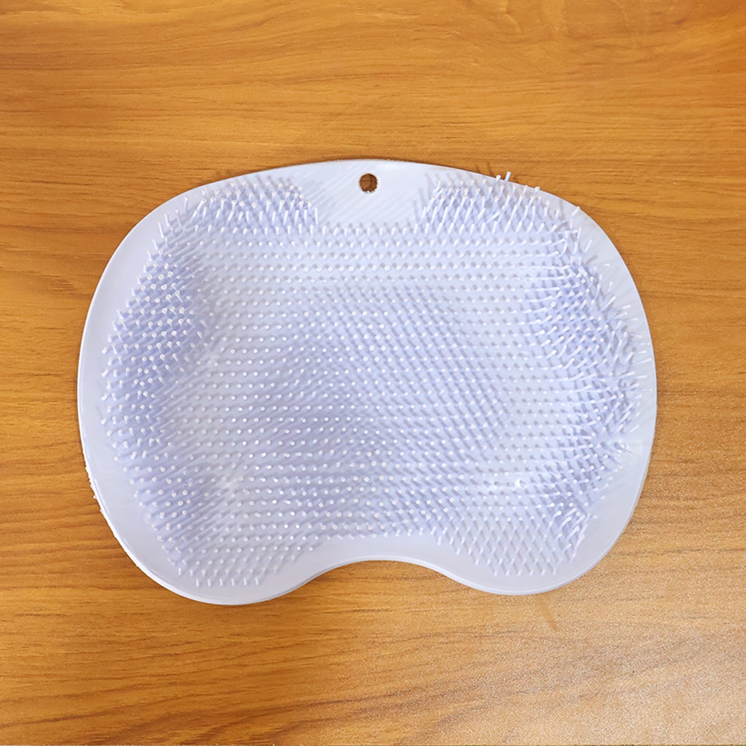 Purple silicone bath massage cushion showing flexible bristles and suction cups