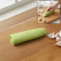 Silicone garlic peeler tube on white background for easy garlic skin removal