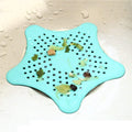 Star-shaped silicone sink hair catcher preventing clogs in a bathroom.