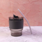 Stylish plastic tumbler with lid and straw, designed for easy portability.