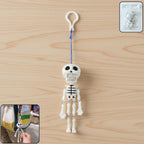 Skeleton doll keychain with clip hook hanging on bag charm