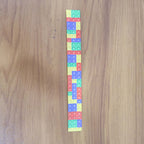 Child wearing colorful snap slap bracelet toy on wrist