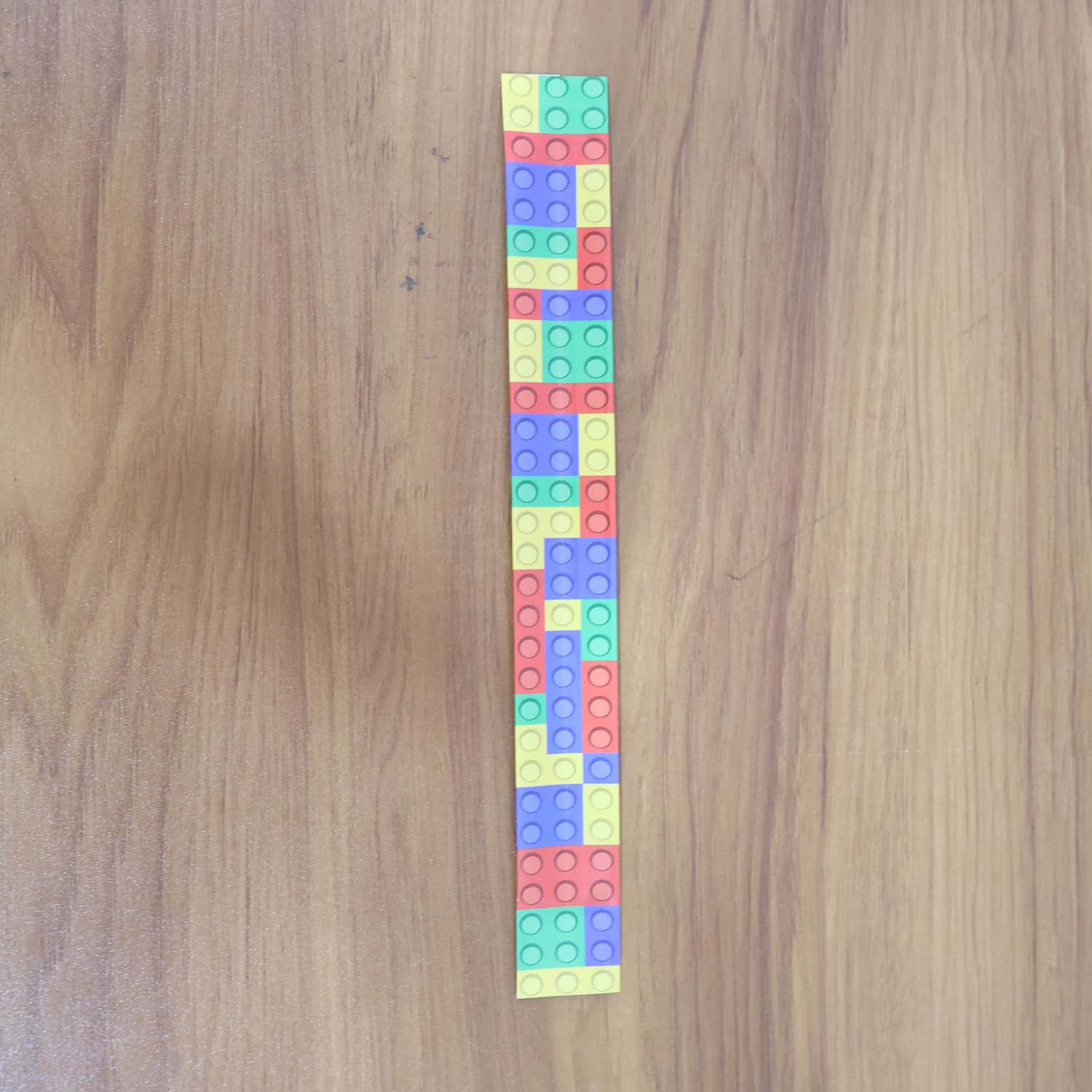 Child wearing colorful snap slap bracelet toy on wrist